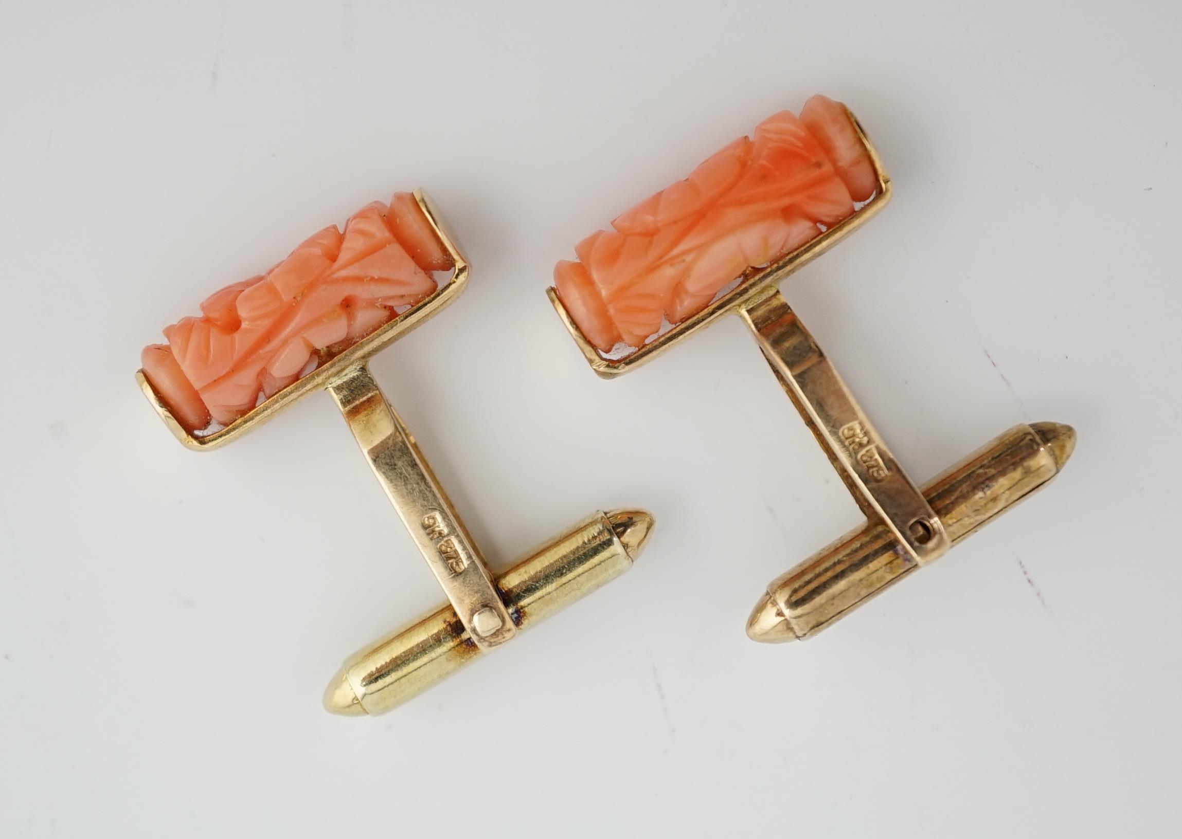 A pair of 9k gold and carved coral set cufflinks